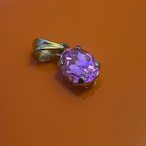 Pink oval crystal on gold locket